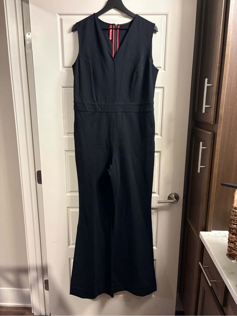 SPANX Black Sleeveless V-Neck Flare Jumpsuit with Red Back Zip Detail
